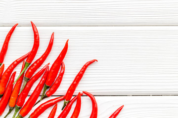Cooking hot food with chilli pepper on white wooden table background top view copy space