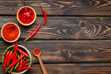 Fresh red chilli pepper and dry powder as food ingredient on wooden table background top view mockup