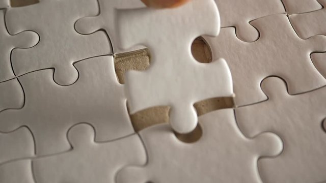 Piece of white jigsaw filling by hand, Success concept
