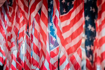Detail and close up shot of waving american flags. Rippled red and white stripes, patriotism and national pride concept. Natural daylight, warm and cool color tones. 