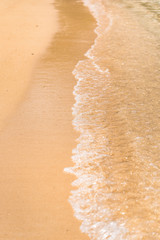 waves crashing on a sandy beach on an island of okinawa in Japan