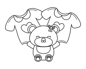 toy bear and baby clothes black and white