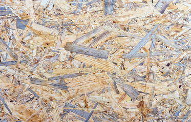 Chipboard background. Rough plywood texture. Plate of compressed sawdust.