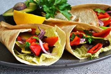 Classic Mexican cuisine. Tacos with beef, avocado, chili and tomatoes. View from above.