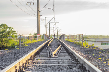 Fototapeta na wymiar railway tracks man walking alone