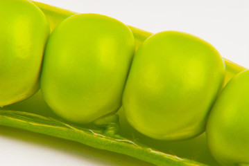 Fresh green peas isolated on a gray background. Macro photography