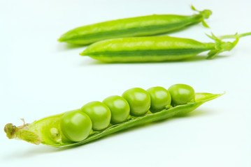 Fresh green peas isolated on a gray background