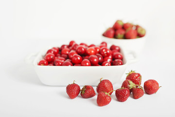 vegetarian and vegan food: strawberries and cherries on a white background, ecological clean products