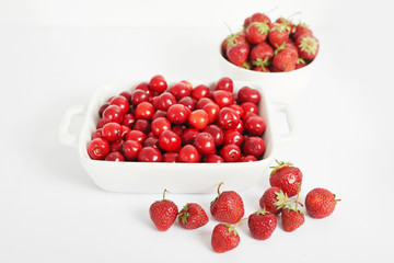vegetarian and vegan food: strawberries and cherries on a white background, ecological clean products