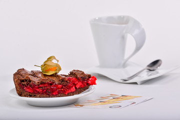 cherry pie decorated with freezalis with a cup of tea