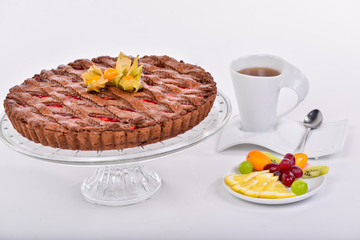 cherry pie decorated with freezalis with a cup of tea