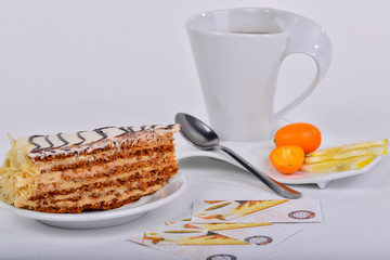 a slice of esterhazy cake with a cup of tea