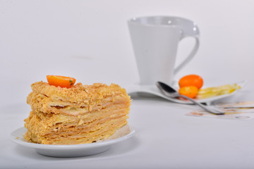 a piece of cake napoleon with a cup of tea