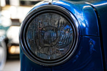 Headlight of antique old car, detail on the headlight of a vintage car. Selective focus