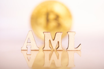 Wood block word AML (Anti Money Laundering). Money laundering bitcoin concept.
