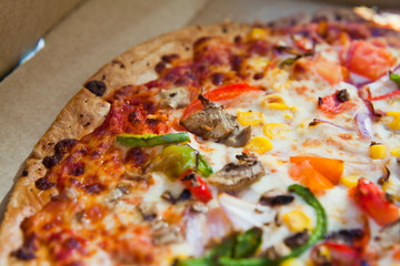 Takeway pizza in the cardboard boxes -  delicious slices ready to enjoy in the sun.