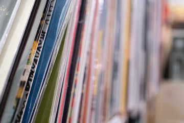 Stack of vinyl LP records inside a vinyl shop. Vintage music store.