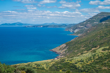Spectacular landscapes, awe-inspiring cliffs, charming villages and historical landmarks along the coastal road between Alghero and Bossa (SP 105), Sardinia, Italy. 