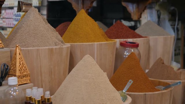 Selection of different arabian spices on a traditional Moroccan market souk in Marrakech, Morocco. A lot of pepper, cardamon, cumin, curry
