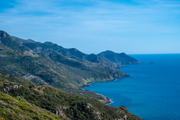 Spectacular landscapes, awe-inspiring cliffs, charming villages and historical landmarks along the coastal road between Alghero and Bossa, Sardinia, Italy. One of the most panoramic spots in Italy.