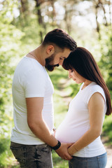 Fototapeta premium Happy young couple expecting baby in summer park