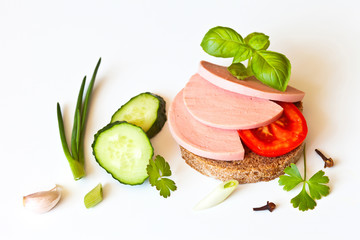 Appetizing sandwich with boiled sausage and vegetables for breakfast. Place for text, white background, close-up view