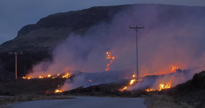 Wildfire near powerlines on the hillside.