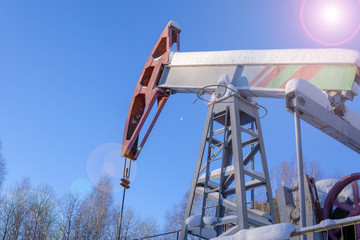 Oil and gas industry. Silhouette oil pumps on a sunset sky background. Toned.