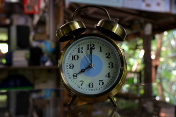 Old retro alarm clock on wooden table