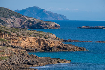 Spectacular landscapes, awe-inspiring cliffs, charming villages and historical landmarks along the coastal road between Alghero and Bossa, Sardinia, Italy. One of the most panoramic spots in Italy.