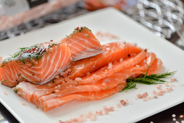 sliced ​​salmon on white square plate