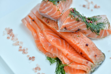 sliced ​​salmon on white square plate