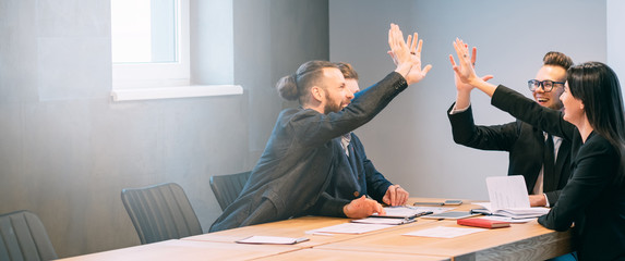 Successful teamwork and cooperation. Young professional team. Business partners in modern...