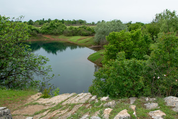 Fototapeta na wymiar Peaceful landscape view of lake hidden in the lush nature, Shegan's Eye, Albania
