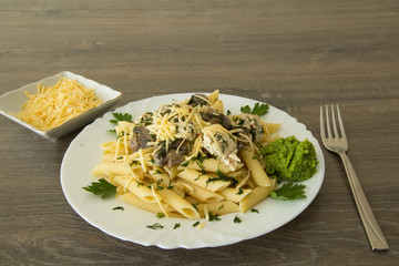 Chicken with mushrooms, pasta, cheese and zucchini sauce