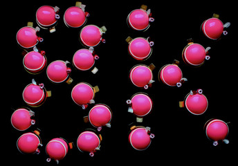 Pink desserts forming 8K on black background, top view
