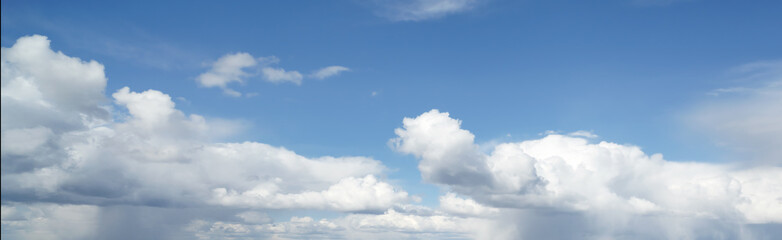 Blue sky in the soft white clouds. Natural cloudscape background, texture. Wide Horizontal Wallpaper