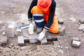Worker To Repair Lays Paving Slabs. Brickwork Close-Up.