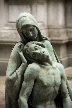 Detail of ancient bronze statue of dead Jesus Christ down from the cross and the Virgin Mary 