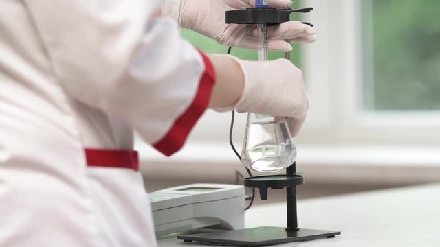 Researchers working in a lab. Professional laboratory medical equipment. pH meter scientific instrument. Healthcare concept.