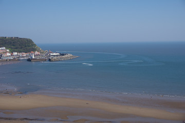 View from clifftops across the bay at Scarborough, Yorkshire, UK on a clear blue sky sunny day