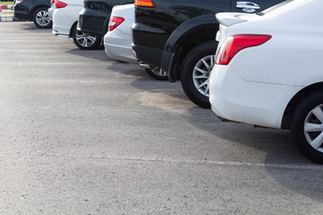 Side view of white car parked in inside outdoor parking line.