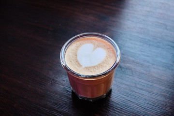 Cup of cappuccino with a heart of foam closeup