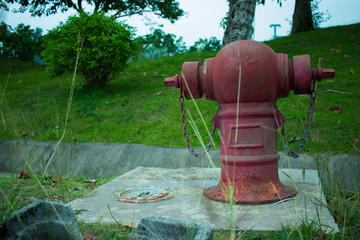 Old Red fire hydrant on a sidewalk