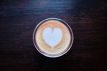 Cup of cappuccino with a heart of foam closeup