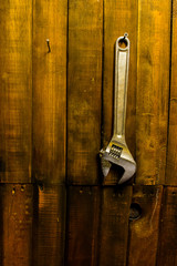 wrench hanging on wooden wall