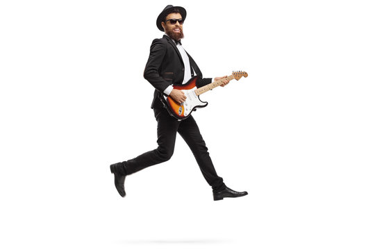 Man performing with an electric guitar and jumping