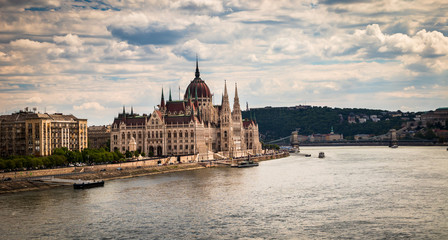 Fototapeta premium Building of the hungarian parliament in a Budapest, capital of Hungary, by the Danube river. One of the landmark of Budapest, and popular tourist destination.