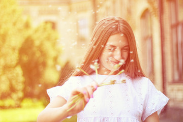 happy, joyful girl with dandelion.positive emotions, summer walk in the park