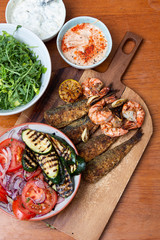 Platter of tasty food, sardines , courgettes and tomato and onion salad 
